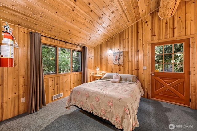 7010 Rainier Way, Deming, WA 98244 - bedroom with lofted ceiling, multiple windows, carpet flooring, wooden ceiling, and wooden walls