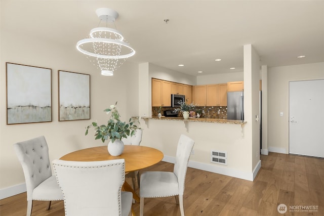 220 1st St Unit 204, Kirkland, WA 98033 - dining space with wood finished floors, recessed lighting, and a chandelier