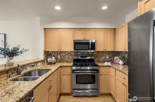 220 1st St Unit 204, Kirkland, WA 98033 - kitchen with stainless steel appliances, light wood-style flooring, tasteful backsplash, light brown cabinets, and recessed lighting