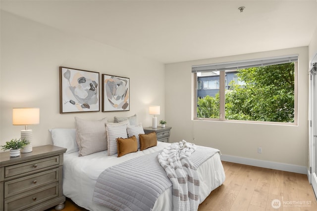 220 1st St Unit 204, Kirkland, WA 98033 - bedroom featuring baseboards and light wood finished floors