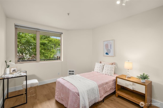 220 1st St Unit 204, Kirkland, WA 98033 - bedroom with wood finished floors and baseboards