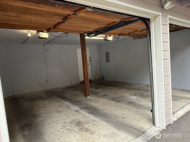 1555 Union Ave NE Unit 56, Renton, WA 98059 - garage with a garage door opener and electric panel