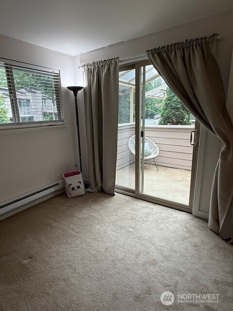 1555 Union Ave NE Unit 56, Renton, WA 98059 - unfurnished room with healthy amount of natural light, carpet floors, and a baseboard radiator