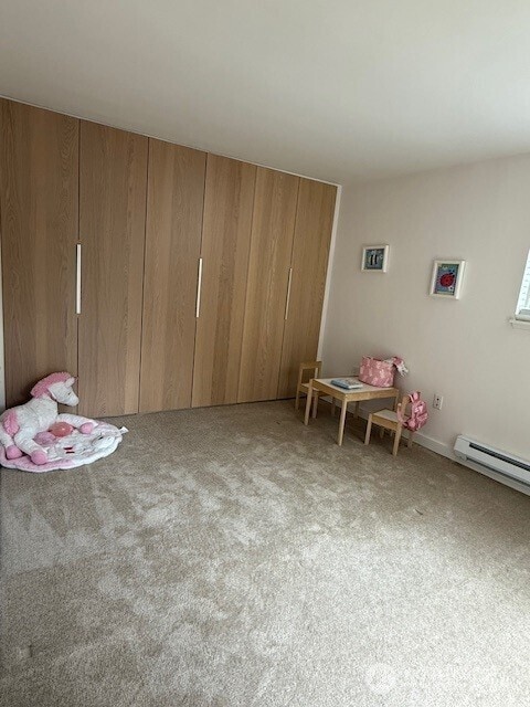 1555 Union Ave NE Unit 56, Renton, WA 98059 - bedroom featuring carpet floors and baseboard heating