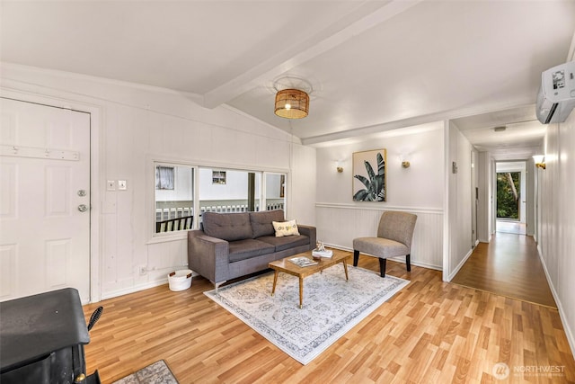 316 W Lake Samish Dr Unit 21, Bellingham, WA 98229 - living room with light wood finished floors, a wall mounted air conditioner, and a decorative wall