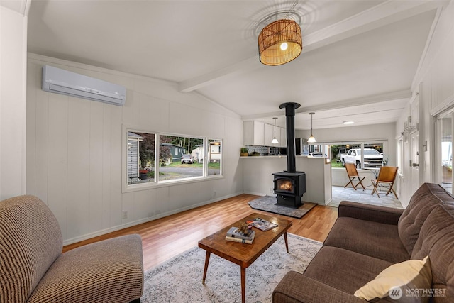316 W Lake Samish Dr Unit 21, Bellingham, WA 98229 - living room featuring an AC wall unit, a wood stove, and light wood-type flooring