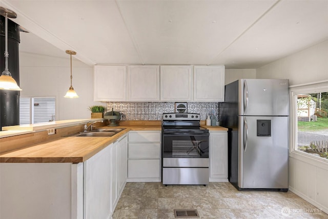 316 W Lake Samish Dr Unit 21, Bellingham, WA 98229 - kitchen featuring stainless steel appliances, a peninsula, wood counters, white cabinets, and backsplash