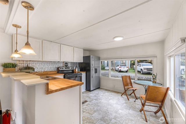 316 W Lake Samish Dr Unit 21, Bellingham, WA 98229 - kitchen with stainless steel appliances, butcher block countertops, healthy amount of natural light, and white cabinetry