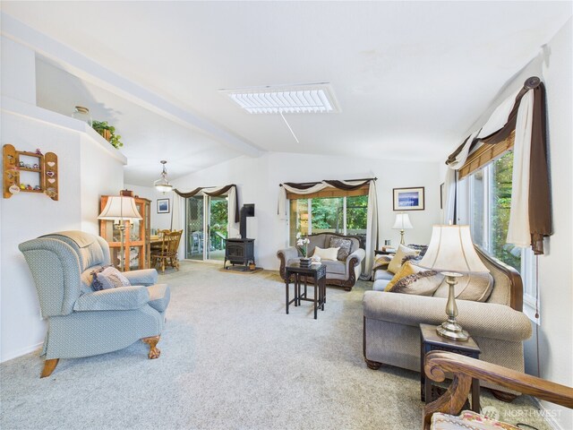 6704 243rd Ave E Unit 96, Buckley, WA 98321 - living area with a wood stove, carpet floors, and lofted ceiling