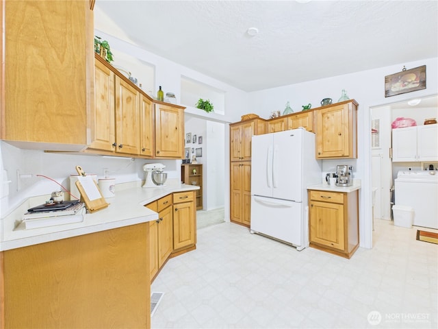 6704 243rd Ave E Unit 96, Buckley, WA 98321 - kitchen featuring freestanding refrigerator, washer / clothes dryer, light floors, and light countertops