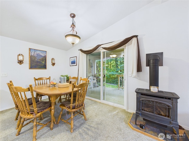 6704 243rd Ave E Unit 96, Buckley, WA 98321 - carpeted dining area featuring a wood stove and baseboards