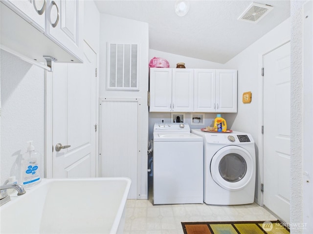 6704 243rd Ave E Unit 96, Buckley, WA 98321 - washroom featuring cabinet space, washer and dryer, and light floors