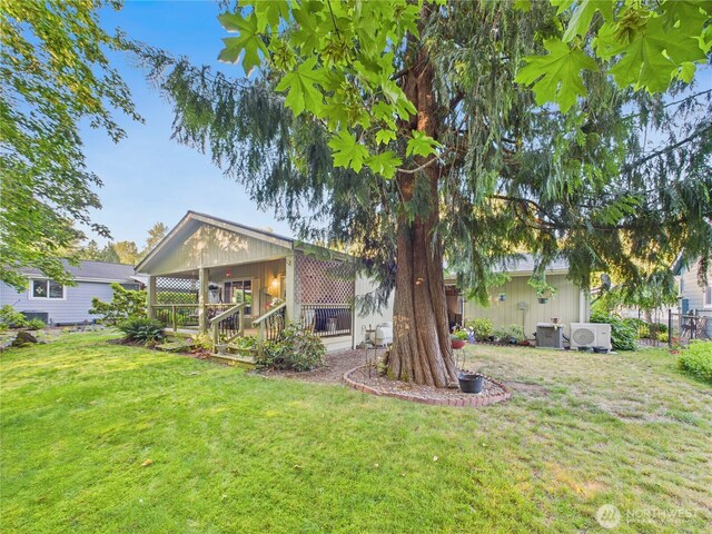 6704 243rd Ave E Unit 96, Buckley, WA 98321 - view of grassy yard featuring a porch