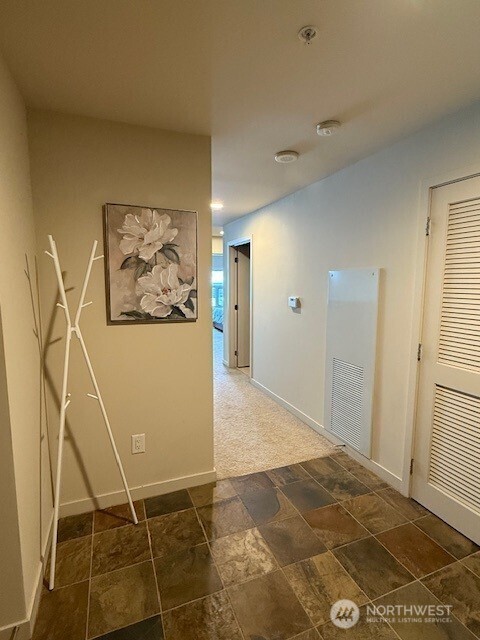 1515 Dock St Unit 210, Tacoma, WA 98402 - hallway with baseboards and stone finish flooring