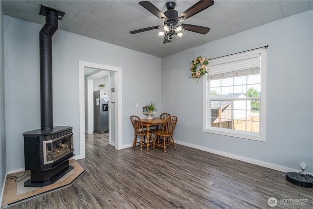 403 S 2nd St, Mccleary, WA 98557 - dining area featuring a wood stove, wood finished floors, and ceiling fan