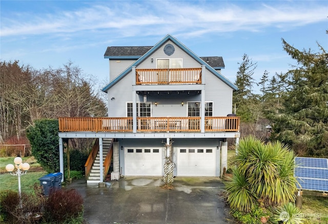 11 Condra Rd, Copalis Beach, WA 98535 - view of front of property featuring a balcony, driveway, an attached garage, and stairway