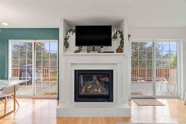11 Condra Rd, Copalis Beach, WA 98535 - living area featuring wood finished floors, plenty of natural light, and a glass covered fireplace
