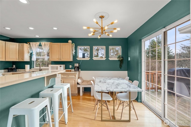 11 Condra Rd, Copalis Beach, WA 98535 - kitchen with white microwave, light brown cabinets, light countertops, light wood-style flooring, and a chandelier