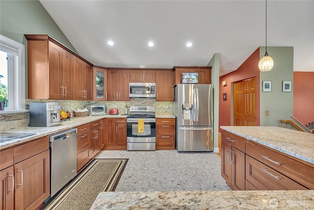 5103 S 302nd Pl, Auburn, WA 98001 - kitchen with stainless steel appliances, lofted ceiling, tasteful backsplash, brown cabinets, and light stone countertops