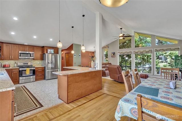 5103 S 302nd Pl, Auburn, WA 98001 - kitchen with appliances with stainless steel finishes, a ceiling fan, decorative backsplash, brown cabinetry, and decorative light fixtures