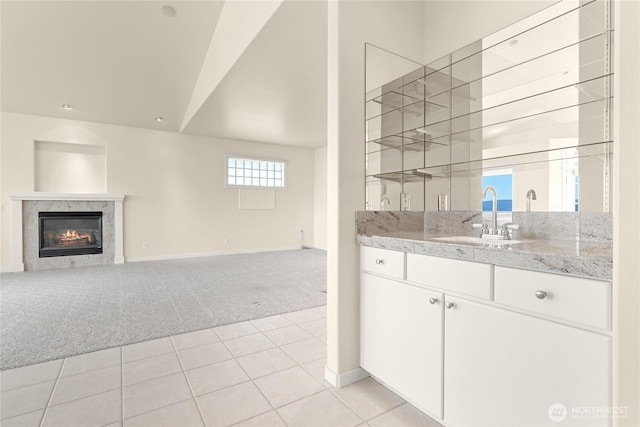 2011 Eldridge Ave, Bellingham, WA 98225 - bar area with light carpet, a high end fireplace, high vaulted ceiling, and light tile patterned floors