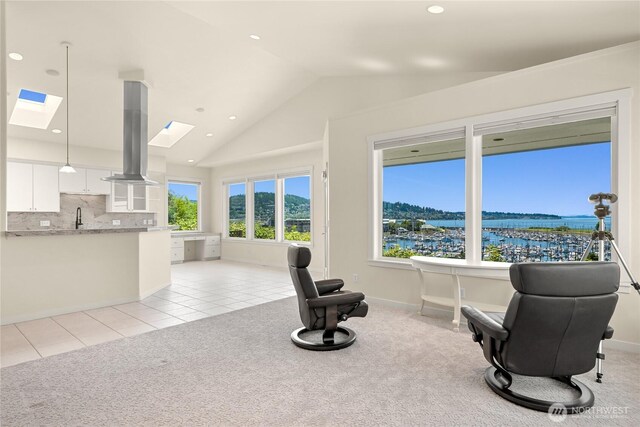 2011 Eldridge Ave, Bellingham, WA 98225 - living area featuring a skylight, lofted ceiling, a water view, light carpet, and light tile patterned floors