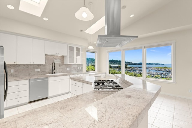 2011 Eldridge Ave, Bellingham, WA 98225 - kitchen with appliances with stainless steel finishes, island range hood, light tile patterned floors, a skylight, and decorative backsplash