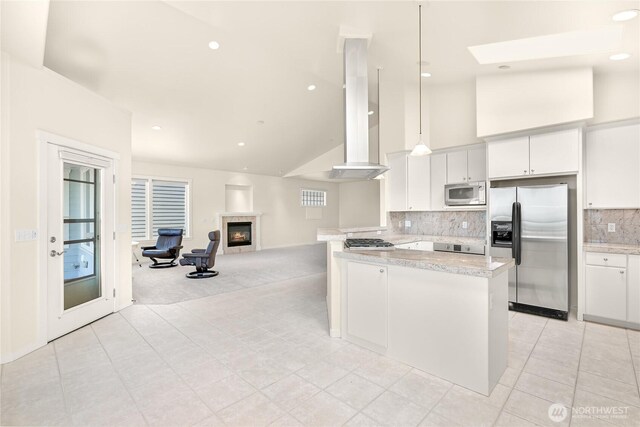 2011 Eldridge Ave, Bellingham, WA 98225 - kitchen featuring stainless steel appliances, white cabinetry, light tile patterned flooring, a tiled fireplace, and high vaulted ceiling