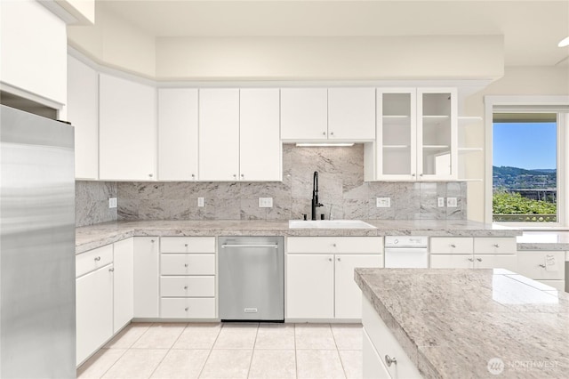2011 Eldridge Ave, Bellingham, WA 98225 - kitchen featuring appliances with stainless steel finishes, backsplash, white cabinetry, and light tile patterned floors