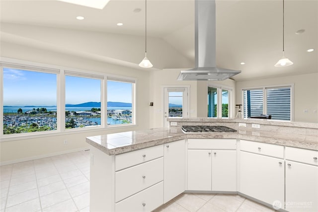 2011 Eldridge Ave, Bellingham, WA 98225 - kitchen featuring island exhaust hood, stainless steel gas cooktop, light countertops, light tile patterned flooring, and lofted ceiling