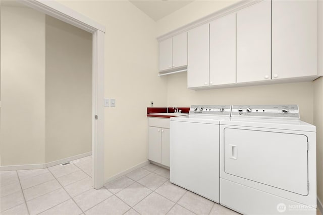2011 Eldridge Ave, Bellingham, WA 98225 - laundry room featuring cabinet space, washing machine and dryer, and light tile patterned floors