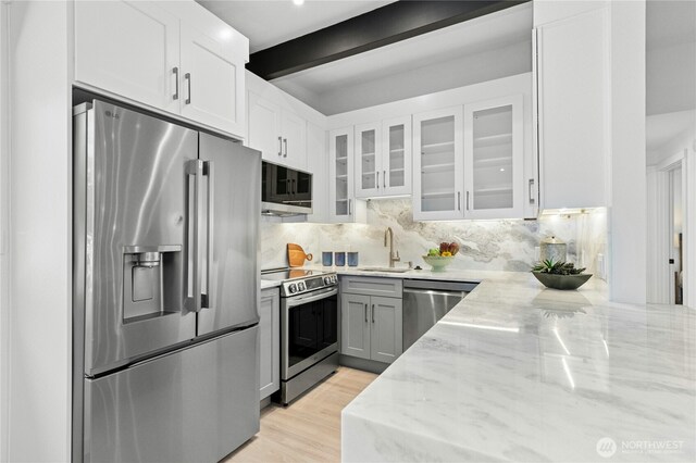 14517 SE 41st Ln, Bellevue, WA 98006 - kitchen featuring appliances with stainless steel finishes, light stone countertops, backsplash, glass insert cabinets, and white cabinetry