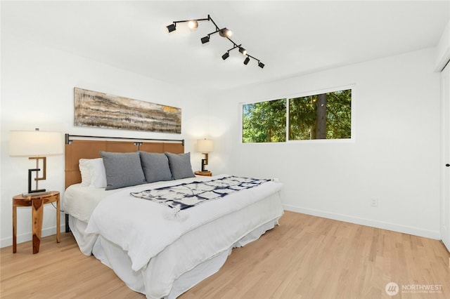 14517 SE 41st Ln, Bellevue, WA 98006 - bedroom with wood finished floors and rail lighting