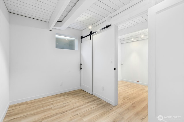14517 SE 41st Ln, Bellevue, WA 98006 - unfurnished room with a barn door, light wood finished floors, and beamed ceiling
