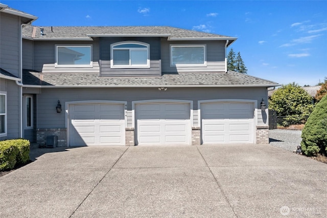 4024RD E Caldwell, Edgewood, WA 98372 - multi unit property featuring concrete driveway, an attached garage, roof with shingles, and brick siding