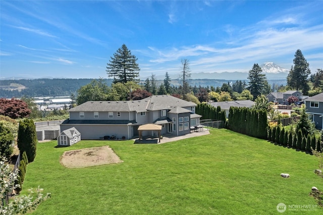 4024RD E Caldwell, Edgewood, WA 98372 - fenced backyard with a patio area, a storage unit, and a gazebo