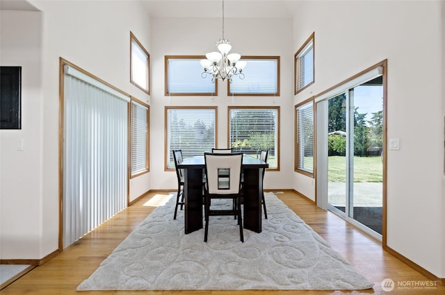 4024RD E Caldwell, Edgewood, WA 98372 - dining room with a chandelier, a high ceiling, and light wood finished floors