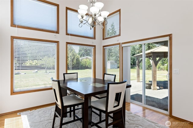 4024RD E Caldwell, Edgewood, WA 98372 - dining room featuring a chandelier, wood finished floors, and a high ceiling