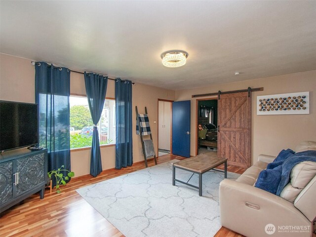136 W 13th St, Port Angeles, WA 98362 - living area with a barn door and wood finished floors