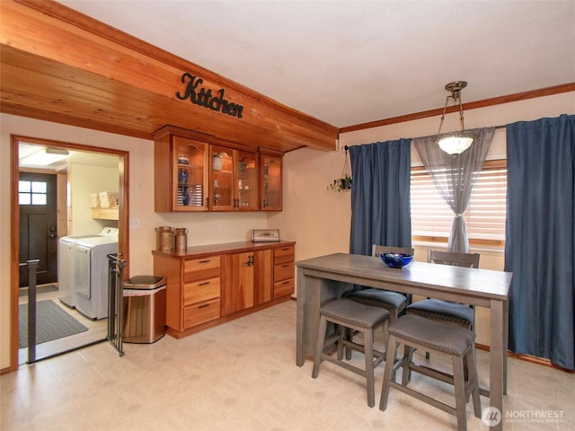 136 W 13th St, Port Angeles, WA 98362 - dining area featuring independent washer and dryer, light floors, and crown molding