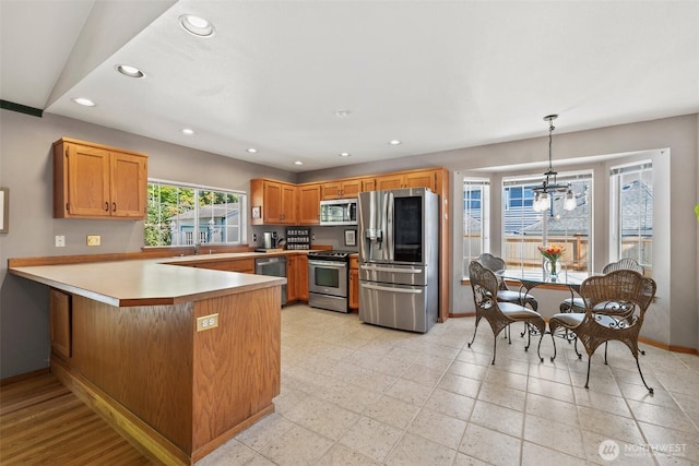 405 S Waugh Rd, Mount Vernon, WA 98274 - kitchen featuring appliances with stainless steel finishes, recessed lighting, a peninsula, light countertops, and decorative light fixtures