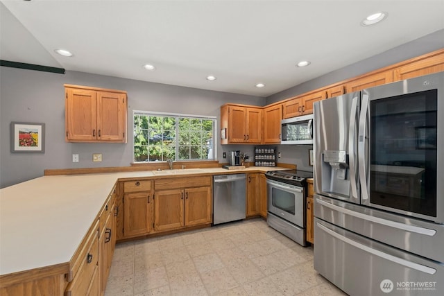 405 S Waugh Rd, Mount Vernon, WA 98274 - kitchen featuring appliances with stainless steel finishes, light countertops, recessed lighting, a peninsula, and light floors