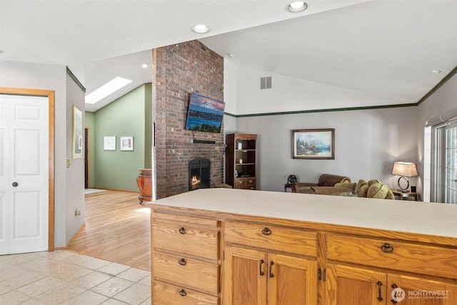 405 S Waugh Rd, Mount Vernon, WA 98274 - kitchen with vaulted ceiling, open floor plan, a brick fireplace, light countertops, and recessed lighting