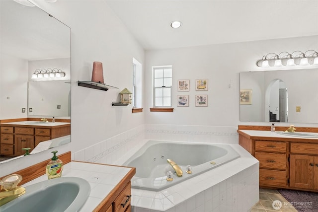 405 S Waugh Rd, Mount Vernon, WA 98274 - full bathroom featuring two vanities, a jetted tub, and tile patterned floors