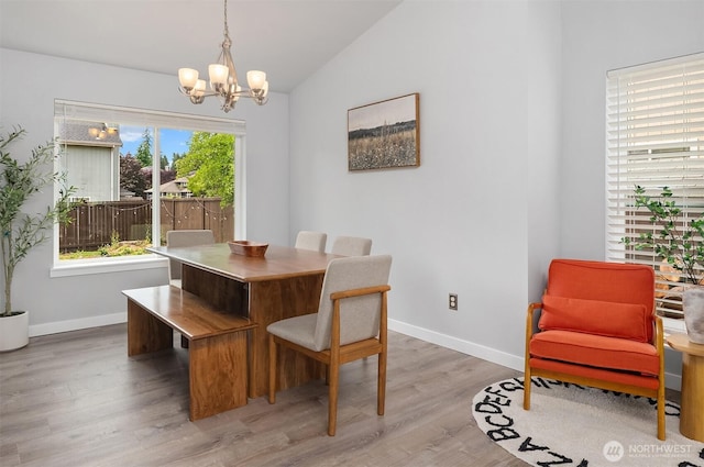 23619 SE 245th St, Maple Valley, WA 98038 - dining room with a chandelier, vaulted ceiling, and light wood-style flooring