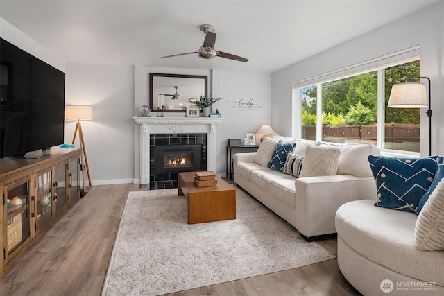 23619 SE 245th St, Maple Valley, WA 98038 - living room featuring ceiling fan, wood finished floors, and a fireplace