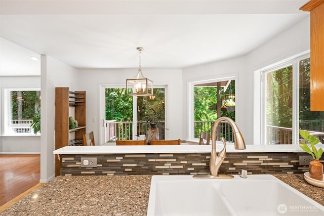 3204 30th St, Bellingham, WA 98225 - kitchen with backsplash, healthy amount of natural light, wood finished floors, and decorative light fixtures