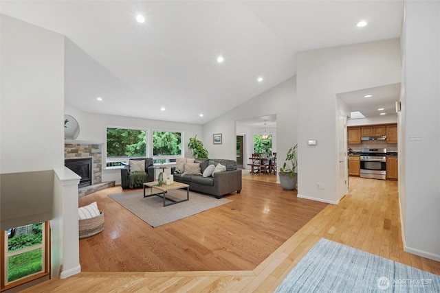 3204 30th St, Bellingham, WA 98225 - living room with light wood-type flooring, a fireplace, recessed lighting, and high vaulted ceiling