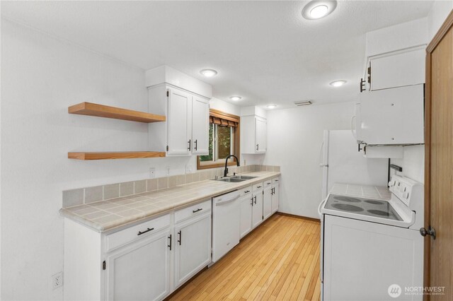 7511 Kittiwake Dr SE, Olympia, WA 98513 - kitchen with white appliances, white cabinetry, light wood-style flooring, open shelves, and recessed lighting