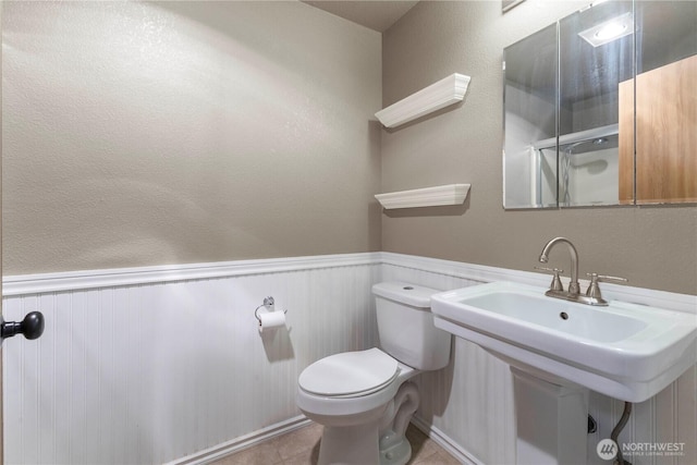 7511 Kittiwake Dr SE, Olympia, WA 98513 - bathroom featuring a wainscoted wall and toilet